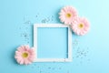 Beautiful gerberas and frame on color background