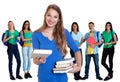 Beautiful german female student with books and group of students Royalty Free Stock Photo