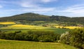 Beautiful German landscape in Hessen in spring. Mountains and rape fields. Royalty Free Stock Photo