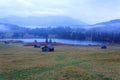 Beautiful Geroldsee on a foggy autumn morning with wooden barns on grassy fields & Karwendel mountain in background Royalty Free Stock Photo