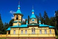 The beautiful Gethsemane Skete of the Valaam Monastery. Blue domes and yellow walls look bright against the backdrop of the forest Royalty Free Stock Photo