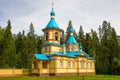 The beautiful Gethsemane Skete of the Valaam Monastery. Blue domes and yellow walls look bright against the backdrop of the forest Royalty Free Stock Photo