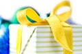 Beautiful gift box with yellow ribbon over white