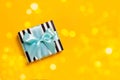 Beautiful gift on a festive bright background with sparkles and tinsel