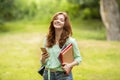 Beautiful Ginger Girl Student Holding Smartphone And Workbooks, Relaxing Outdoors After Classes Royalty Free Stock Photo