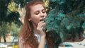 Beautiful ginger woman on diet eating pine needles