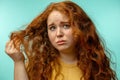 Upset and woman with her damaged dry hair face expression blue background Royalty Free Stock Photo