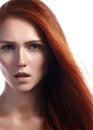 Beautiful ginger young woman with flying hair and naturel makeup. Beauty portrait of model with straight red hair Royalty Free Stock Photo