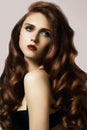 Beautiful ginger young woman with luxury hair style and fashion gloss makeup. Beauty closeup model with red hair