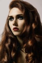 Beautiful ginger young woman with luxury hair style and fashion gloss makeup. Beauty closeup model with red hair