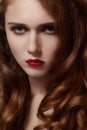 Beautiful ginger young woman with luxury hair style and fashion gloss makeup. Beauty closeup model with red hair Royalty Free Stock Photo