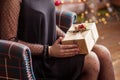 Beautiful gir with cristmas gift box. lWoman`s hands holding gold gift box. Christmas, new year, birthday concept. Festive