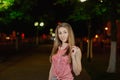 Beautiful girl in the alley in the park in the evening.