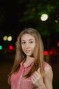 Beautiful girl in the alley in the park in the evening.