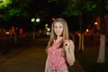 Beautiful girl in the alley in the park in the evening.