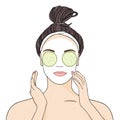 Beautiful girl applies face mask and cucumbers on white background.