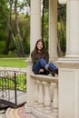 The beautiful girl on an arbour handrail