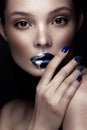 Beautiful girl with art make-up, dark glitter lips design and manicured nails. beauty face. Royalty Free Stock Photo