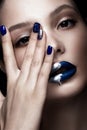 Beautiful girl with art make-up, dark glitter lips design and manicured nails. beauty face. Royalty Free Stock Photo