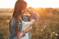 Beautiful girl in autumn field reading a book. The girl sitting on a grass, reading a book. Rest and reading. Outdoor reading Royalty Free Stock Photo