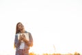 Beautiful girl in autumn field reading a book. The girl sitting on a grass, reading a book. Rest and reading. Outdoor reading Royalty Free Stock Photo