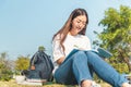 Beautiful girl in autumn forest reading a book covered with a warm blanket.a woman sits near a tree in an summer forest and holds