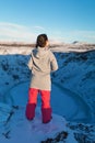 Beautiful girl on the background of lake Kerid frozen in winter in the crater of an extinct volcano. Incredible iceland landscape Royalty Free Stock Photo