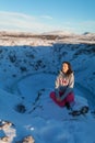 Beautiful girl on the background of lake Kerid frozen in winter in the crater of an extinct volcano. Incredible iceland landscape Royalty Free Stock Photo