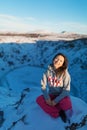 Beautiful girl on the background of lake Kerid frozen in winter in the crater of an extinct volcano. Incredible iceland landscape Royalty Free Stock Photo