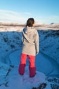 Beautiful girl on the background of lake Kerid frozen in winter in the crater of an extinct volcano. Incredible iceland landscape Royalty Free Stock Photo