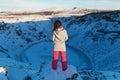 Beautiful girl on the background of lake Kerid frozen in winter in the crater of an extinct volcano. Incredible iceland landscape Royalty Free Stock Photo