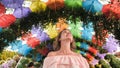 Beautiful girl on the background of multi-colored umbrellas in the park of the city. Royalty Free Stock Photo