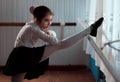 Girl ballet dancer practicing on the barre