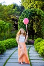 Beautiful girl with balloon have a fun in the park.