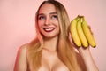 Beautiful girl with bananas in studio, isolated. Food, fashion, healthcare, cosmetology concept, space for text