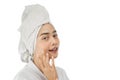 beautiful girl with bath towel on head with finger pose gently holding cheek with copy space