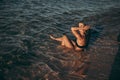 Girl bathing and tanning in a shallow water