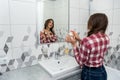 Beautiful girl in the bathroom applies cream on her face. beauty concept Royalty Free Stock Photo