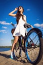 Beautiful girl on the beach with cruiser bicycle Royalty Free Stock Photo