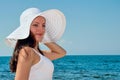 Beautiful girl on the beach in the hat