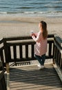 beautiful girl on the beach watching the sunset Royalty Free Stock Photo