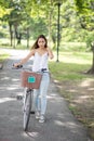 Beautiful girl with bicycle in park
