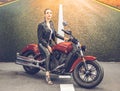Beautiful girl-biker classic motorcycle