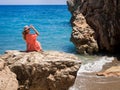 Beautiful girl in a bikini, hat and tunic sunbathing Royalty Free Stock Photo