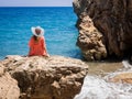 Beautiful girl in a bikini, hat and tunic sunbathing Royalty Free Stock Photo