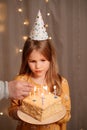 Girl with birthday cake. tradition to make wish and blow out fire Royalty Free Stock Photo