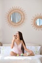 Beautiful girl biting cake while having breakfast in bed Royalty Free Stock Photo