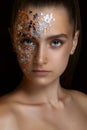 beautiful girl on a black background. beauty portrait close-up. Gold particles on the face
