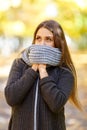 Beautiful girl in a black coat on a background of autumn park. Royalty Free Stock Photo