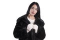 Beautiful girl in a black fur coat, stylish white sweater holiday mittens isolated portrait Royalty Free Stock Photo
